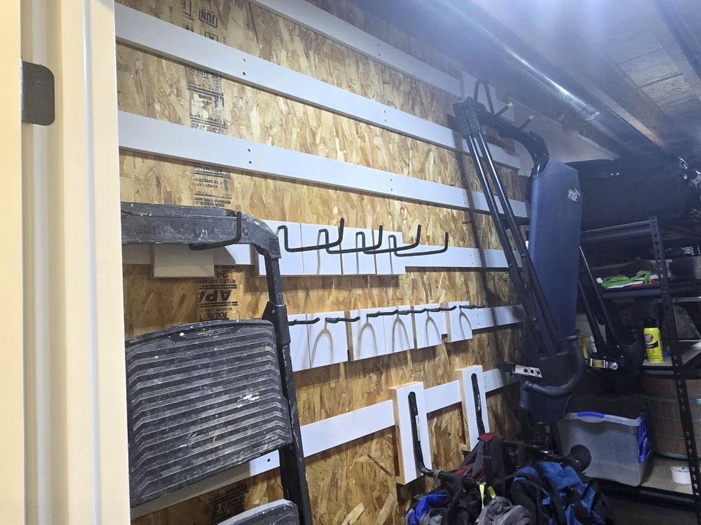 Close up of locking cleat holders mounted on plywood holding helmets and floor mats
